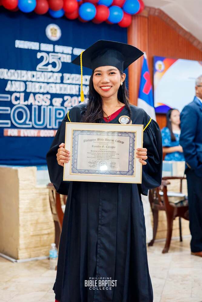 A graduate of the Philippine Bible Baptist College holding her diploma at commencement